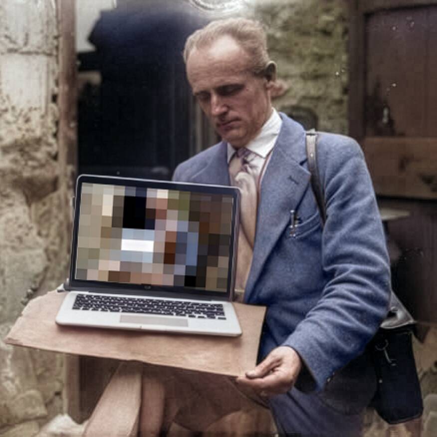 Man in business attire holding wooden table with laptop displaying pixelated color palette squares